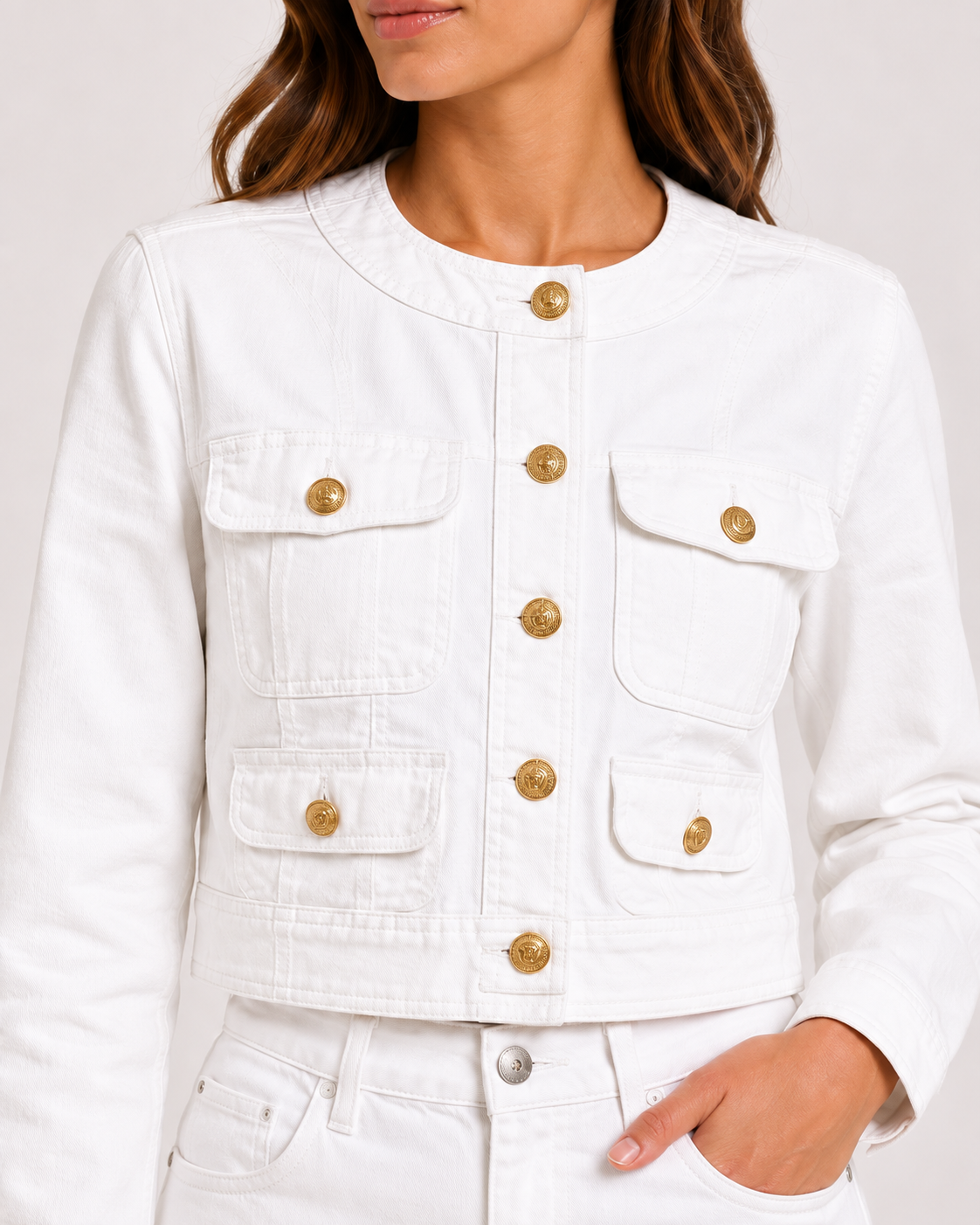 White military denim jacket gold buttons and pockets close-up