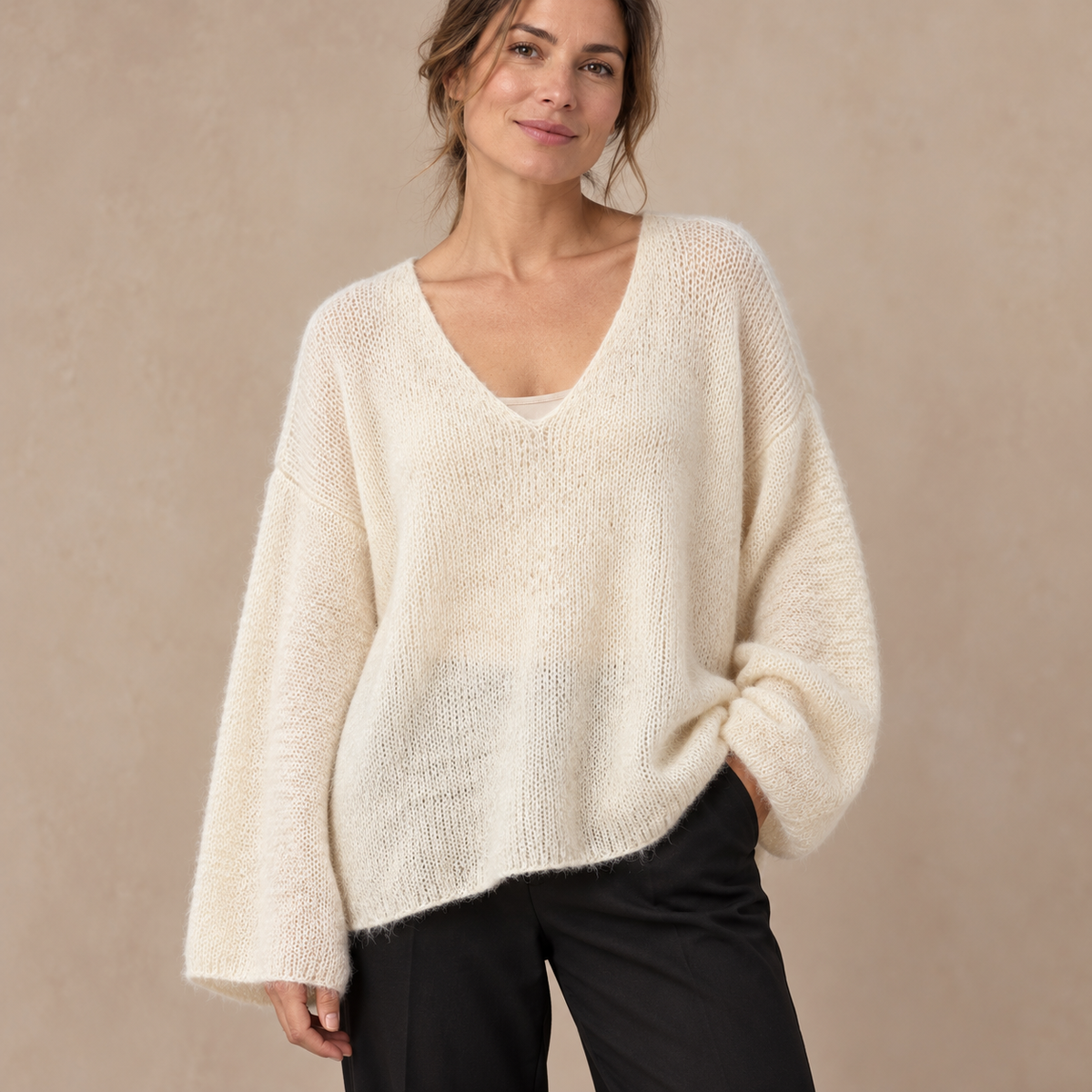 Model wearing cream fluffy open-knit V-neck jumper