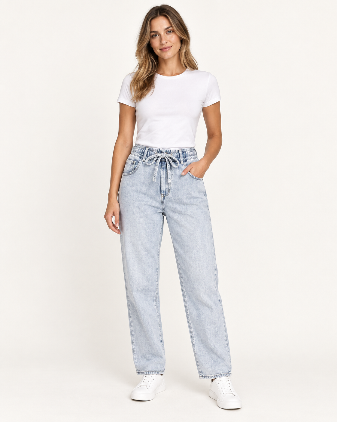 Female model wearing women's light wash denim joggers