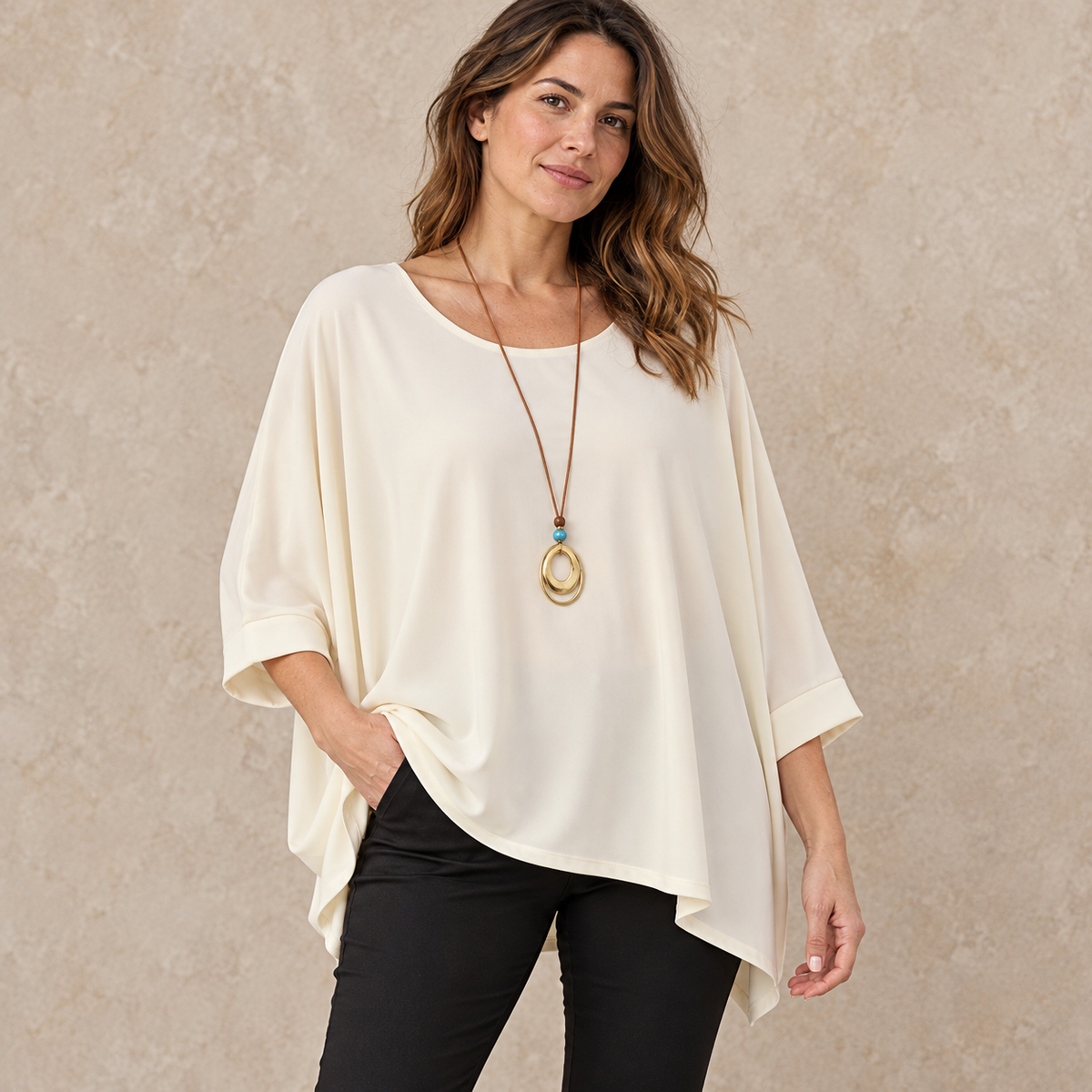 Model wearing cream relaxed batwing top