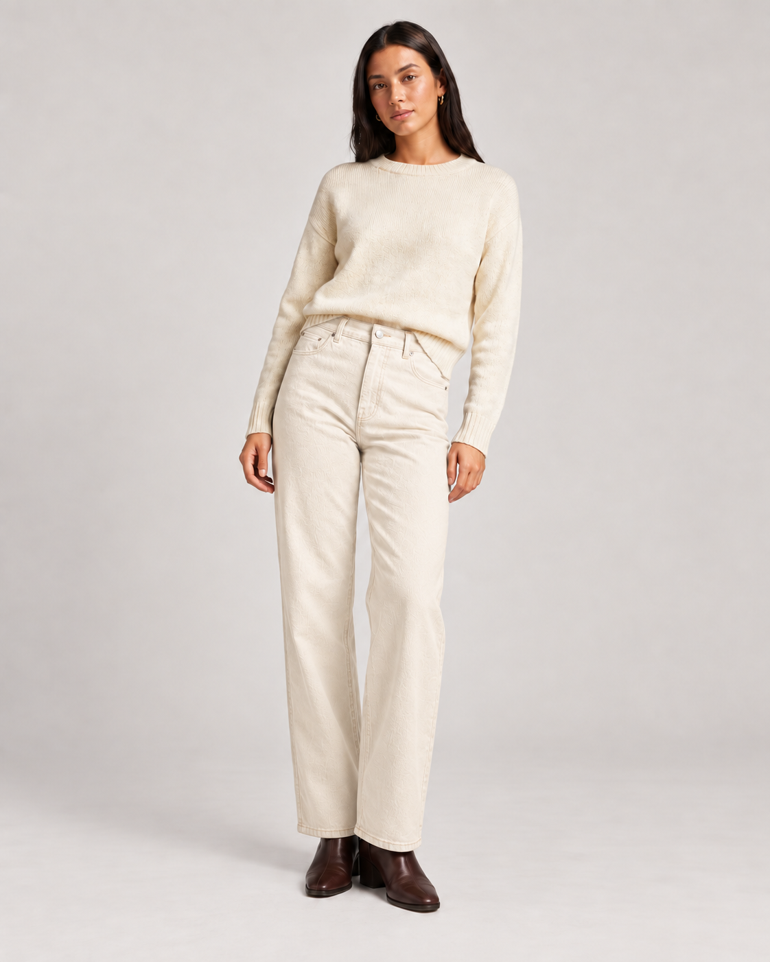 Ecru wide leg jeans on a model against a neutral studio background