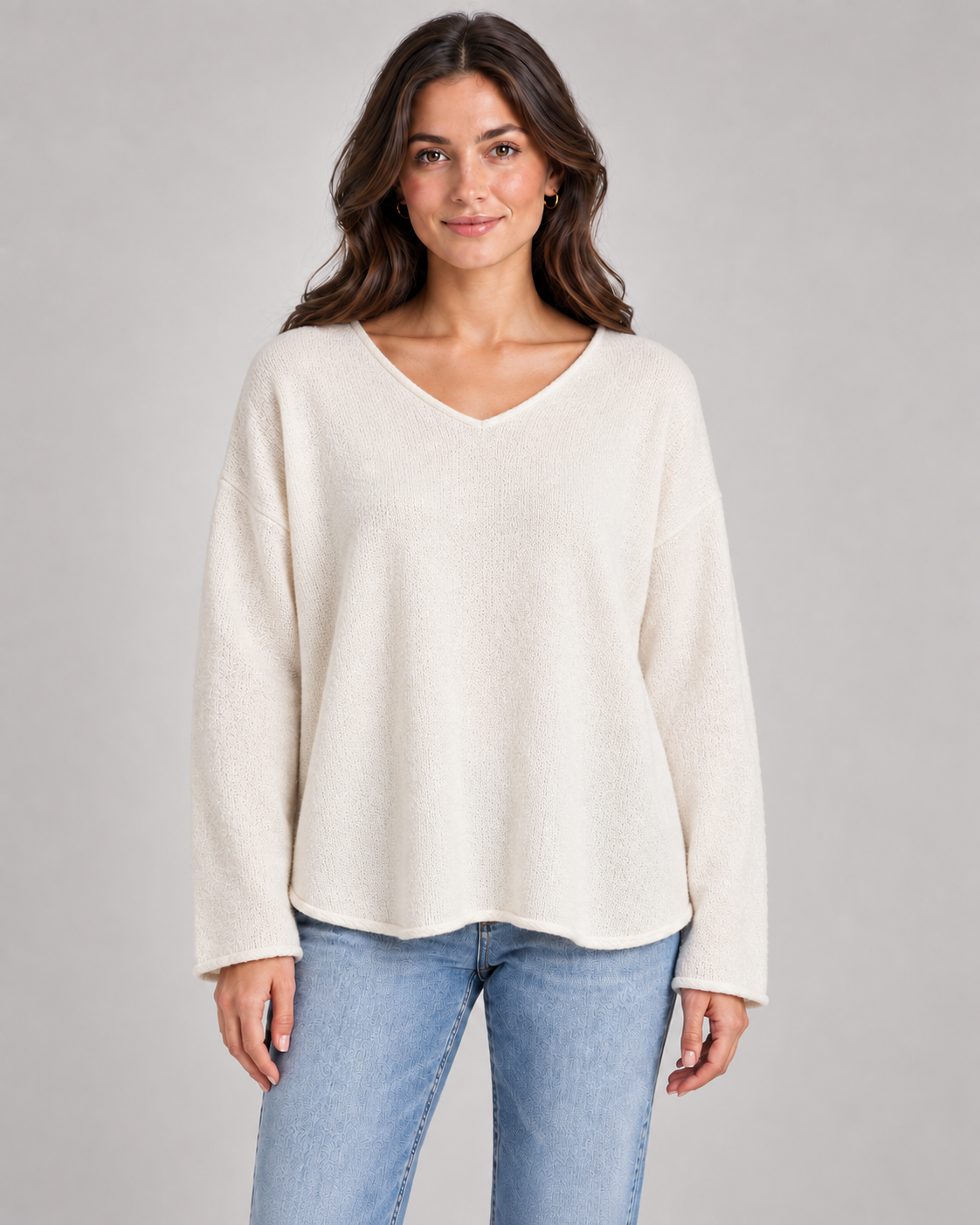 Women's V-neck fine knit top in cream on a female studio model