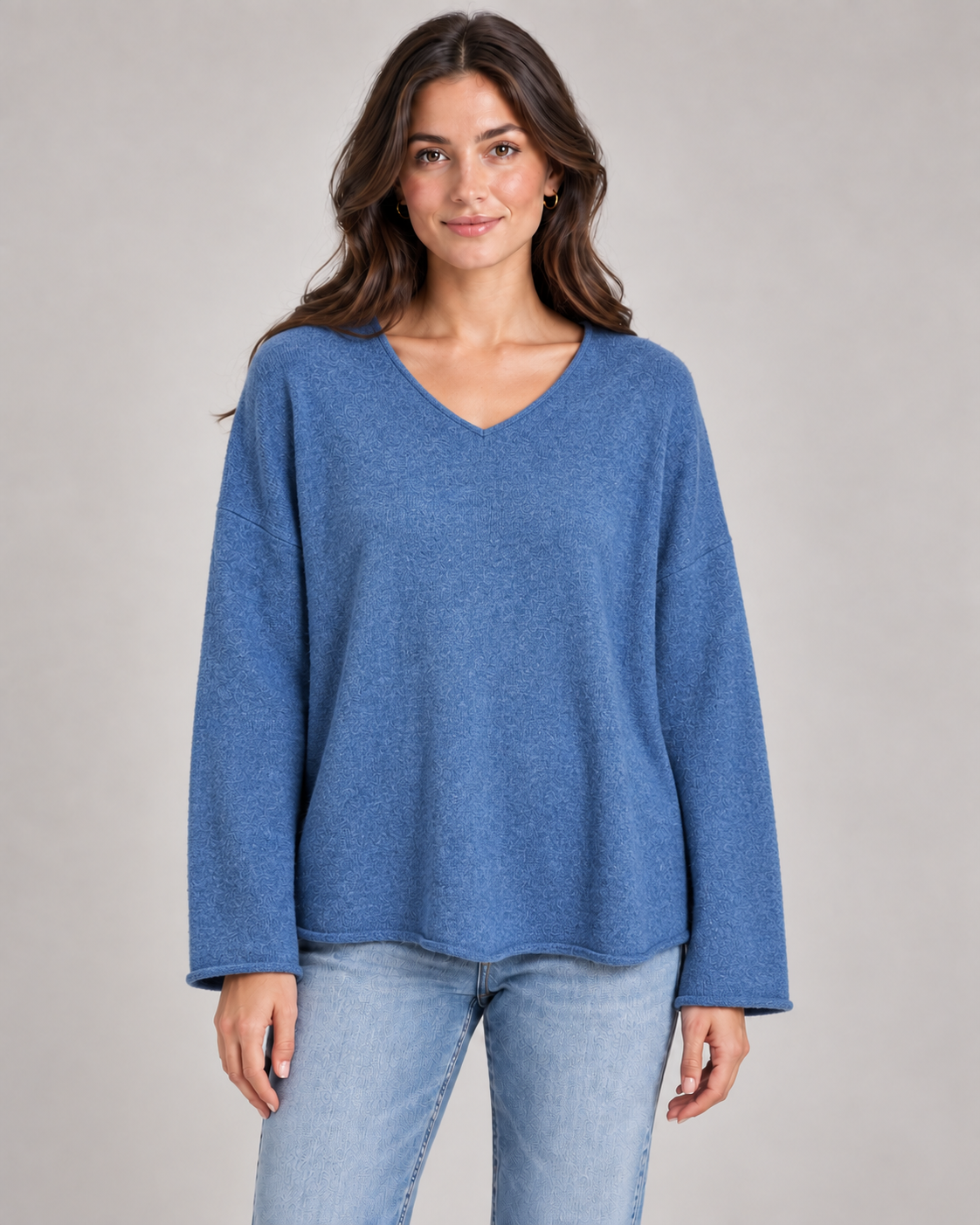Women's V-neck fine knit top in denim blue on a female studio model